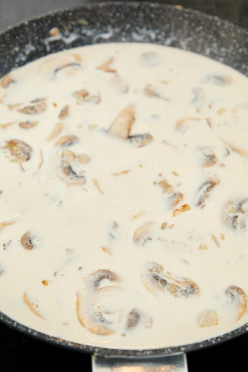 Creamy mushroom sauce in a frying pan. Rich, savory mushroom sauce perfect for pasta or steak.