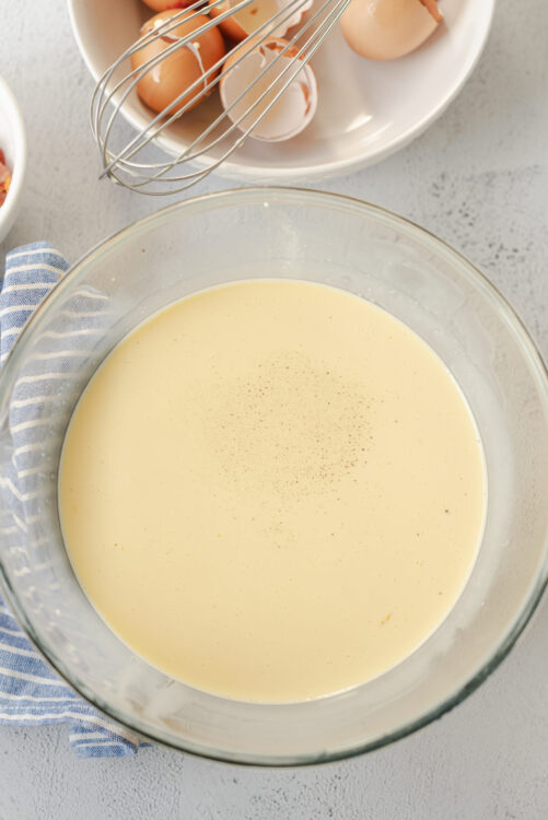 Creamy custard mixture in a glass bowl for baking recipes.
