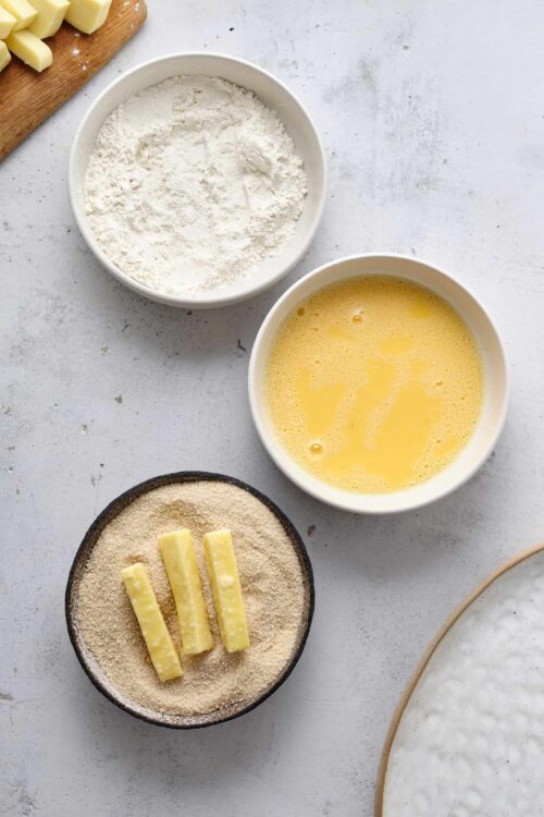 Flour, eggs, and butter on a baking table for pastry or baking recipes.