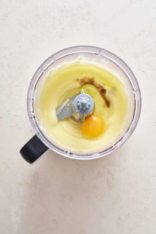 Beaten eggs and ingredients in a blender for baking, close-up of a baking mixture.