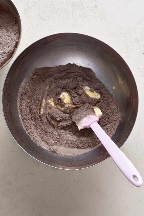 Rich chocolate cake batter with butter in a mixing bowl, ready for baking.