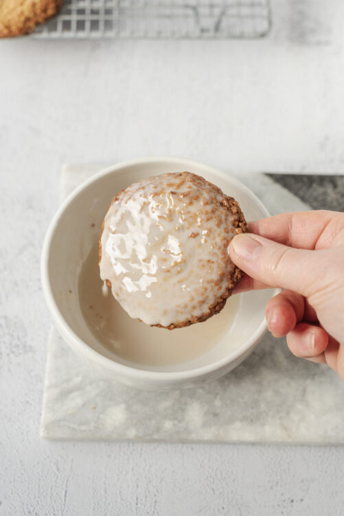 Butter cookie with glaze on white bowl, freshly baked sweet treat, baked Bree, delicious homemade cookie, glazed cookie in hand, bakery dessert, cookie for dessert, baked goods, sweet snack, cozy homemade baking.