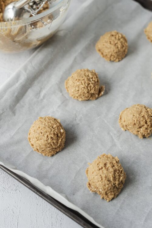 Butterscotch cookie dough balls on parchment paper ready to bake, baked Bree recipe, sweet baked treats, easy dessert ideas, homemade cookies.