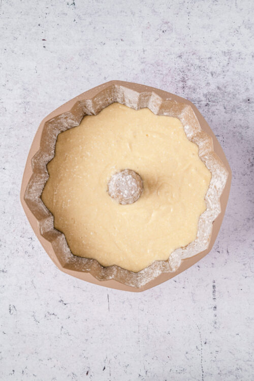 Butter cake batter in a bundt pan ready to bake.