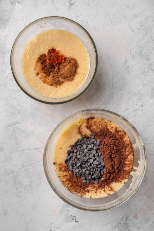 Rich chocolate chip cookie dough ingredients in glass bowls, ready for baking.