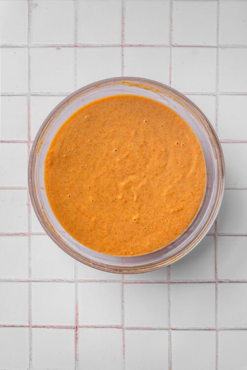 Creamy homemade peanut sauce for salads and stir-fry drizzled over dishes.
