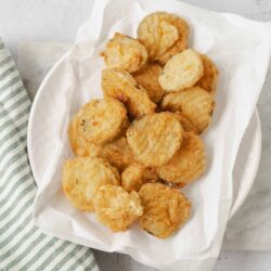 Crispy homemade fish nuggets served on parchment paper in a white dish. Perfect for a quick seafood snack or dinner.