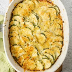 Butternut squash casserole with crispy breadcrumbs in a white baking dish.