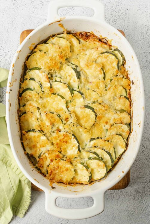Butternut squash casserole with crispy breadcrumbs in a white baking dish.