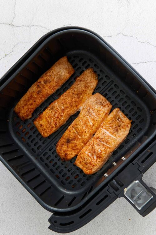 Juicy salmon fillets seasoned and cooked in an air fryer.