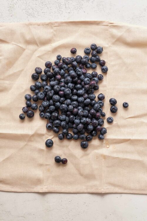 Fresh organic blueberries on parchment paper for baking or cooking.