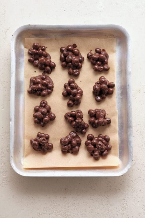 Rich chocolate-covered clusters on parchment paper.