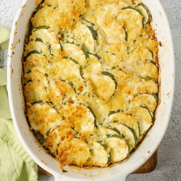 Butternut squash casserole with crispy breadcrumbs in a white baking dish.