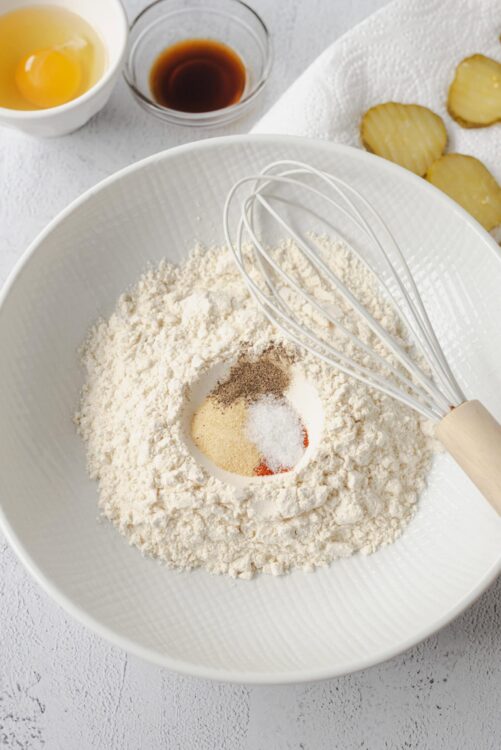 Flour, spices, and salt in a mixing bowl for baking bread or pastries.