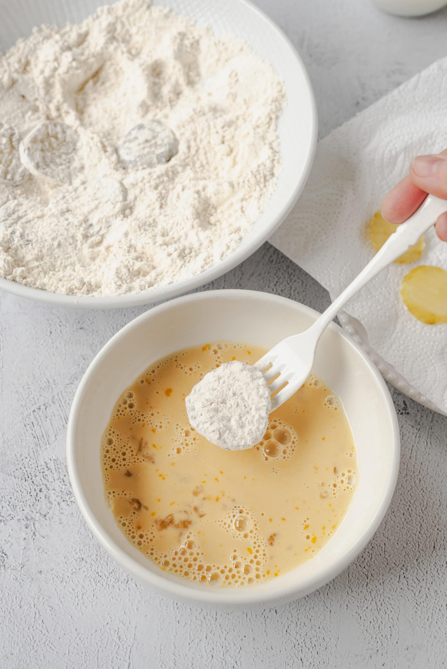 Flour being added to beaten eggs for baking recipe.