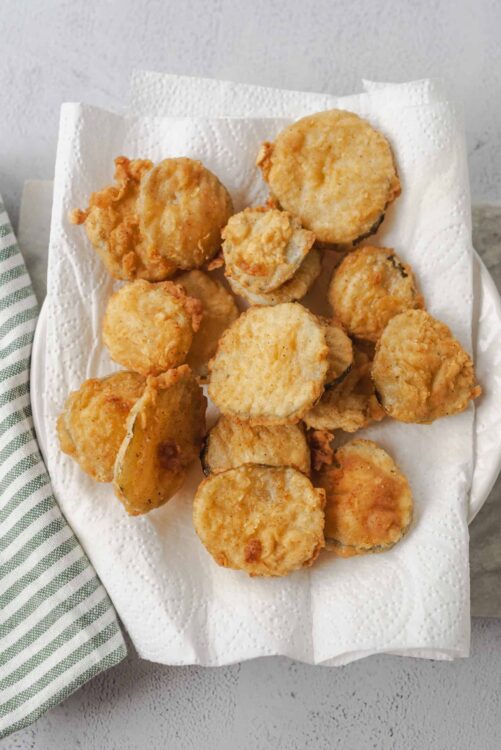 Crispy fried fish nuggets on paper towel, seafood, golden brown, homemade fish fry.