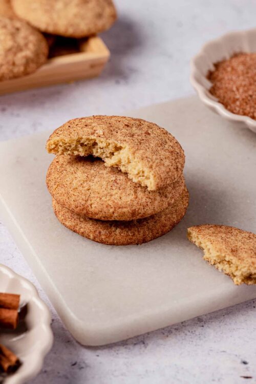 Buttery snickerdoodle cookies on a marble surface with cinnamon sugar coating. Easy homemade cookie recipe perfect for baking and snacking.