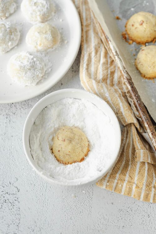 Creamy lemon snowball cookies coated in confectioners' sugar ready for baking.