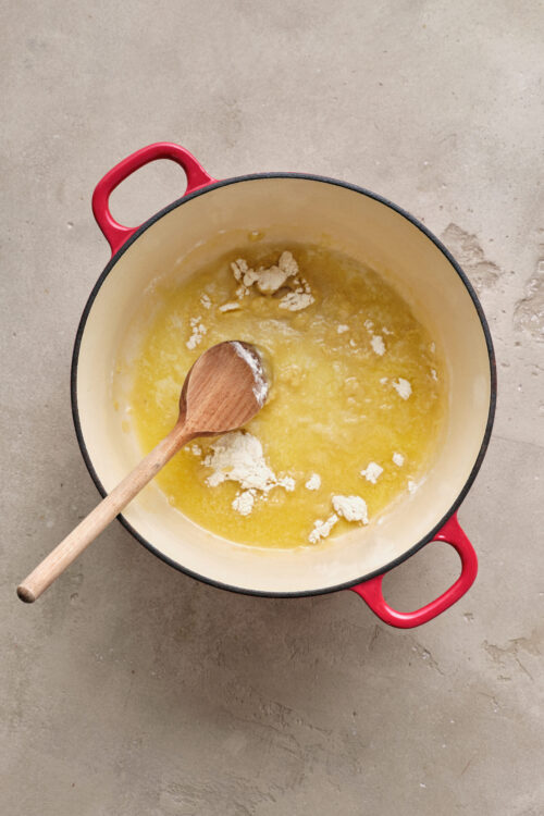 Buttery melted butter and flour mixture in a red Dutch oven for baking or cooking.