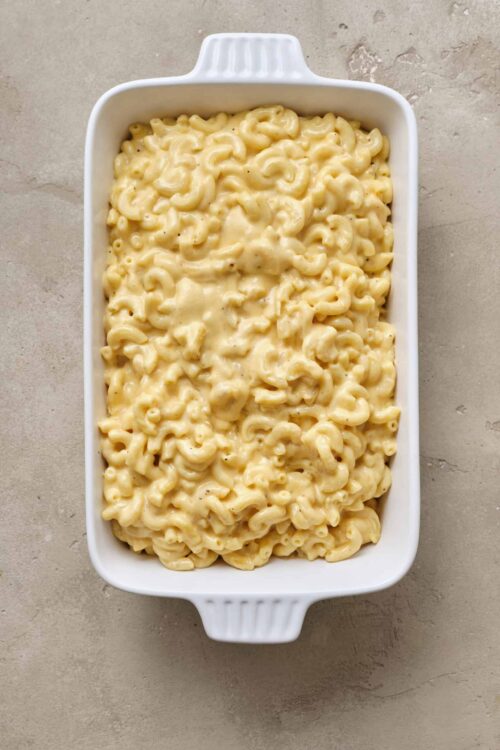 Creamy homemade macaroni and cheese in a white baking dish.