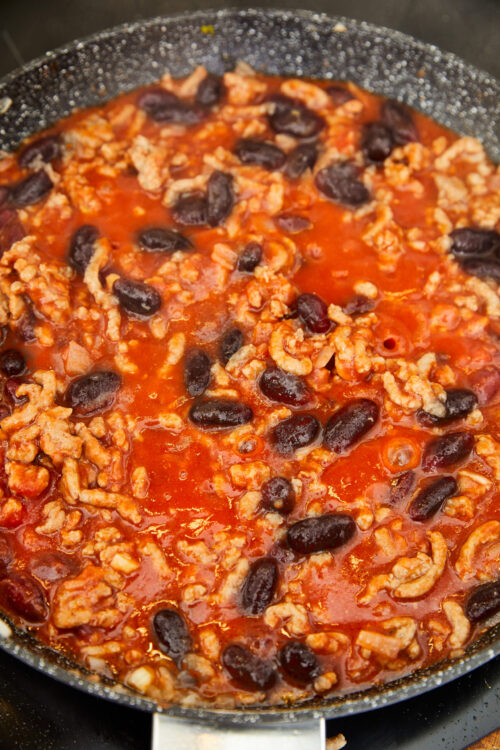 Savory ground turkey chili with black beans in a skillet.