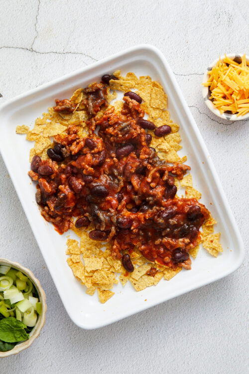 Cheesy chili baked tortilla casserole dish with beans and ground beef.