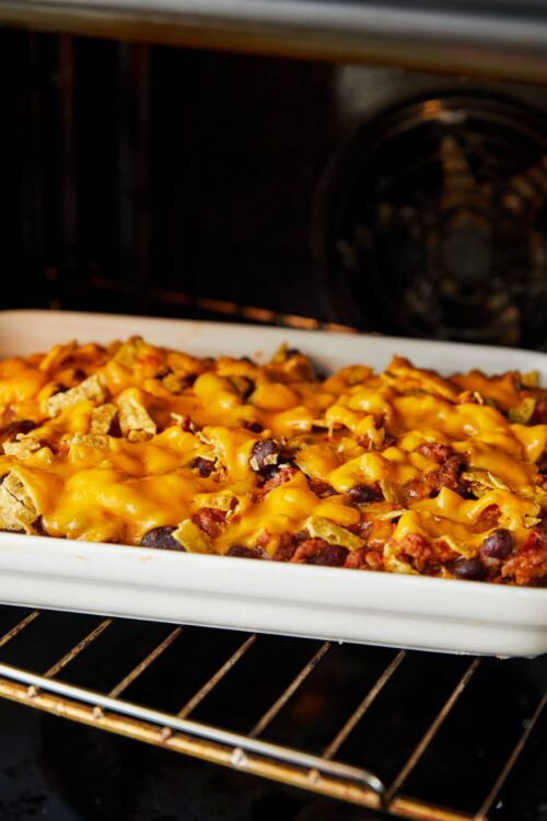 Cheesy baked casserole with beans, ground beef, and crispy tortilla chips.