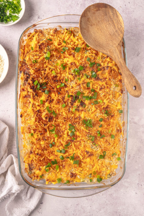 Cheesy baked casserole with green onions, golden crust, and savory topping.