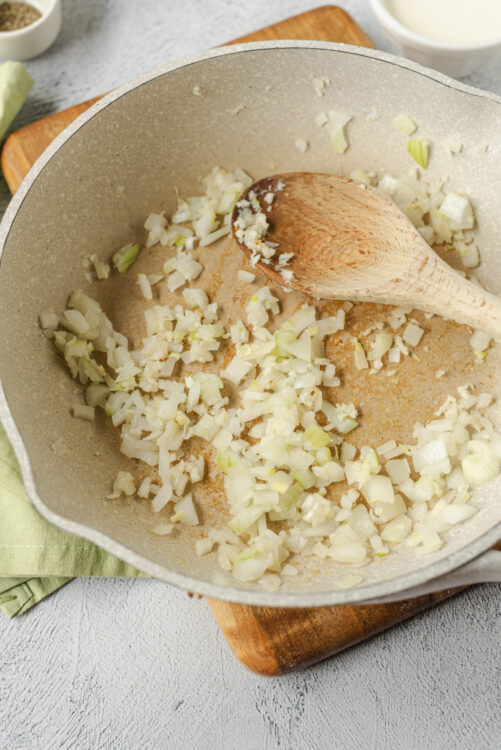Sautéed onions and garlic in a non-stick skillet for flavorful cooking.