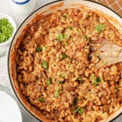 Creamy baked spaghetti with ground beef and tomato sauce in a casserole dish.