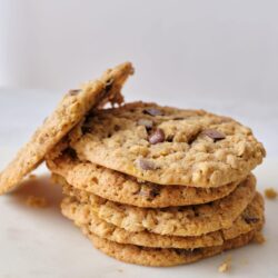 Butterscotch chip cookie stack on a white surface, close-up of freshly baked cookies.