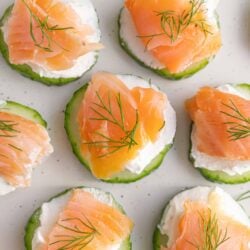 Smoked salmon canapé bites with cream cheese, cucumber, and fresh dill. Perfect appetizer for parties and gatherings.