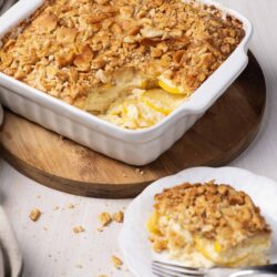 Buttered lemon custard dessert with a crunchy crumble topping, served in a white baking dish.