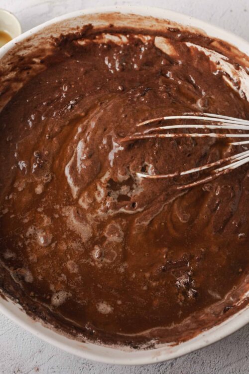 Creamy chocolate cake batter with a rich, smooth texture in a white mixing bowl.