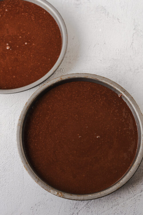 Rich chocolate tart filling in two round baking pans.