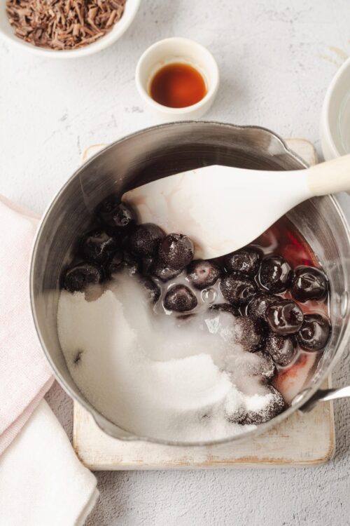Fresh cherries, sugar, and vanilla for cherry pie filling prep.