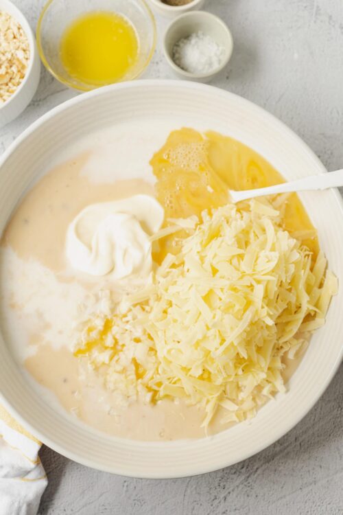 Creamy cheese, eggs, and dairy ingredients for cheesy baked egg casserole.