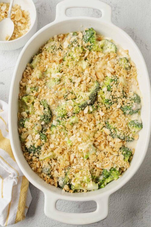 Cheeseburger casserole with vegetables and crispy topping in a white baking dish.