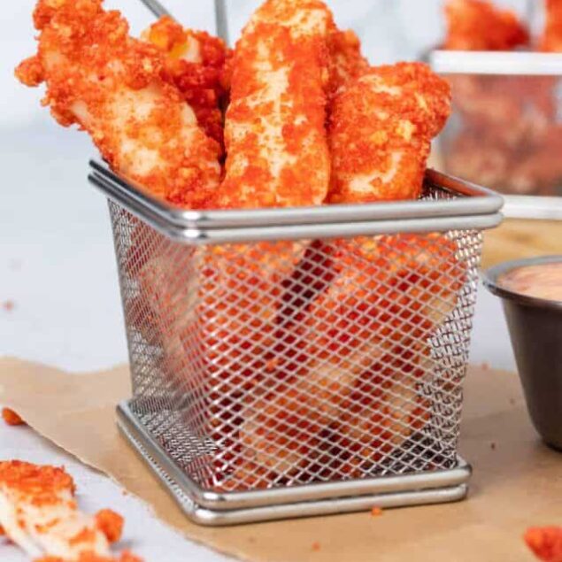 Golden crispy homemade chicken tenders in a metal basket for a delicious snack or meal.
