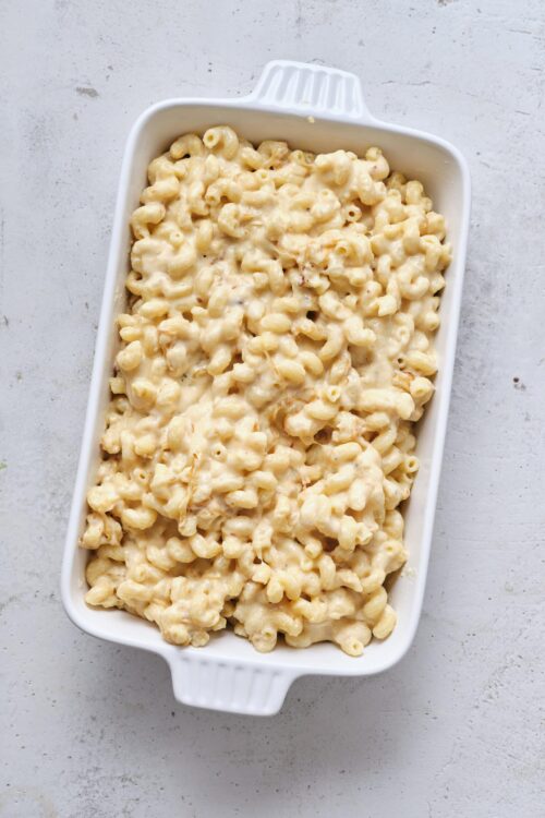 Creamy macaroni and cheese baked dish in a white casserole dish.