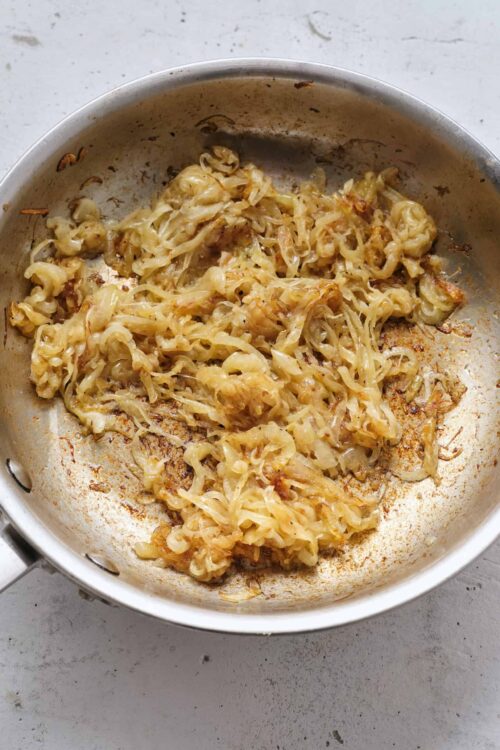 Sautéed cabbage in a stainless steel skillet.