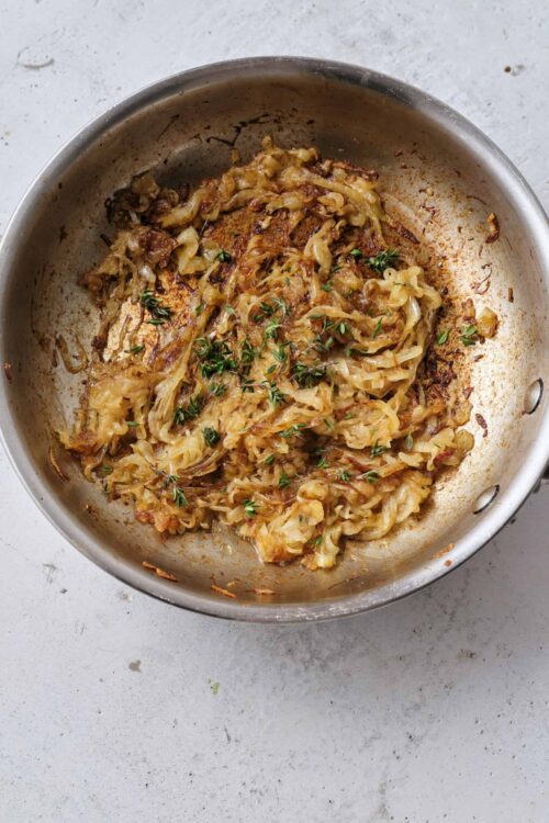Savory caramelized onion hash in a stainless steel skillet.
