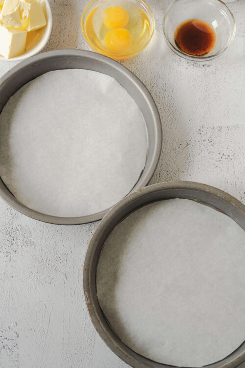 Eggs, butter, vanilla, and baking ingredients ready for cake baking process.