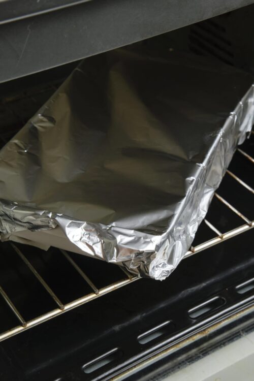 Baked Bree oven baking tray covered with aluminum foil in the oven.
