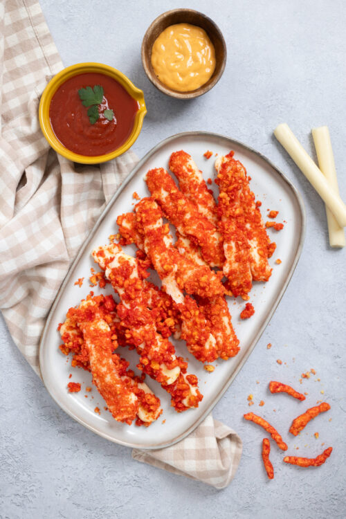 Crispy baked chicken tenders with orange crumbs, served with cheese and dipping sauces.