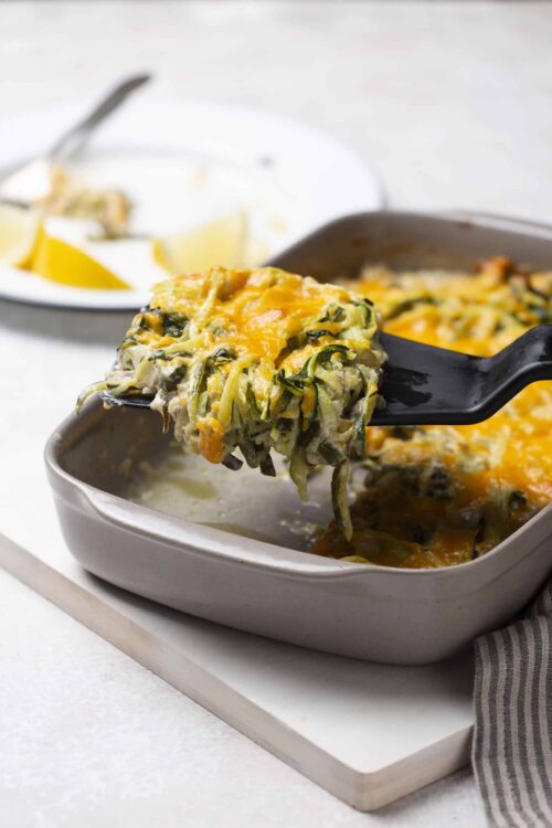 Cheesy vegetable lasagna casserole with zucchini noodles and melted cheese on top.