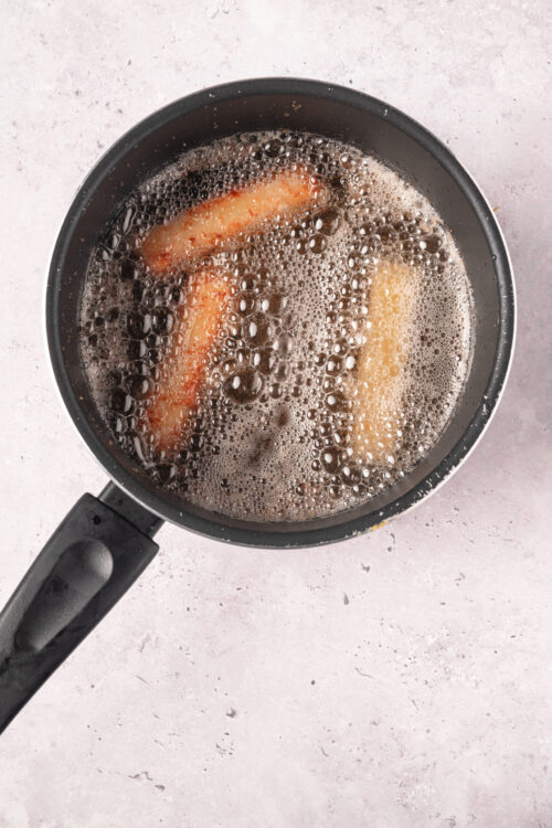 Frying banana in hot oil for baking or recipes.