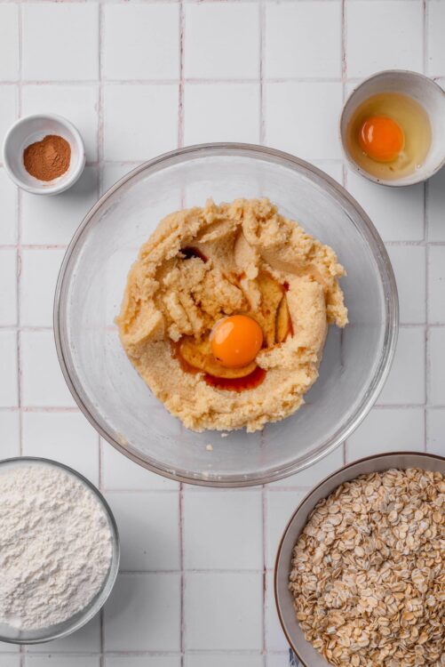 Creamy cookie dough with an egg in a mixing bowl for baking at Baked Bree.