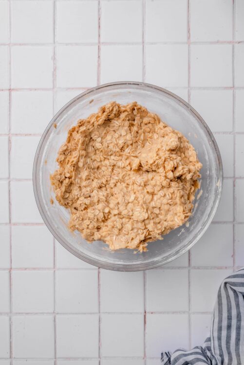 Creamy oatmeal cookie dough in a glass bowl, ready for baking or chilling.