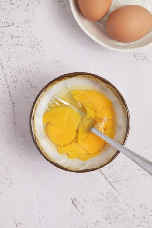 Eggs crack into a bowl for baking or cooking. Fresh eggs are key ingredients in many baked goods and recipes.